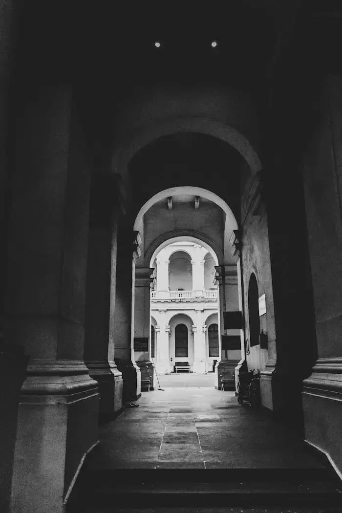 services-02 Monochrome view of a historical buildings archway in Kolkata, India.